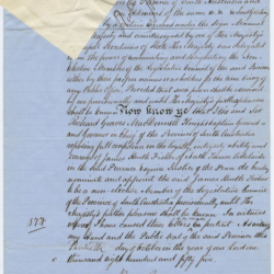 This document in hand written on blue lined paper. It has a wax seal in the top left corner which is covered by a small white paper square to protect it.