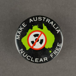 A black badge with a shape of Australia in green and the words make Australia nuclear free in white.