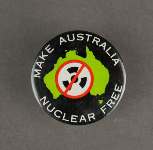 A black badge with a shape of Australia in green and the words make Australia nuclear free in white.