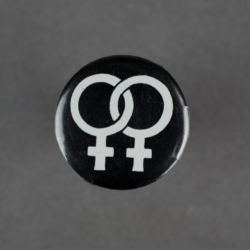A black badge with two interlinked womans symbols in white.