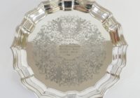 A silver plate with pinched edges all around.