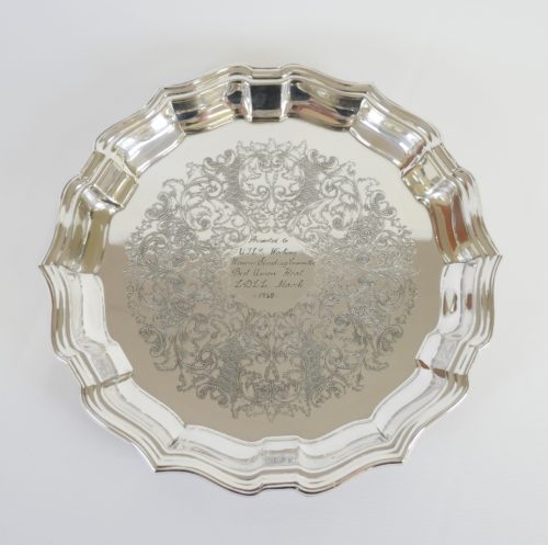 A silver plate with pinched edges all around.