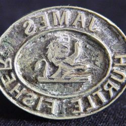 A small metal sealing stamp with the name James hurtle fisher embossed into it. In the centre is a small depiction of a lion.