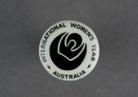 International Women's Year badge in black and white